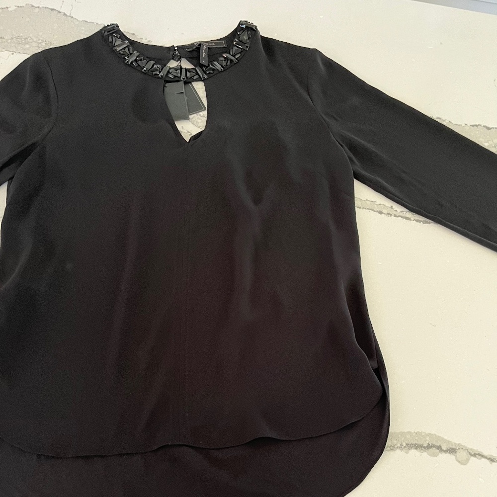 Black blouse with keyhole in front and opening in back, new with tags